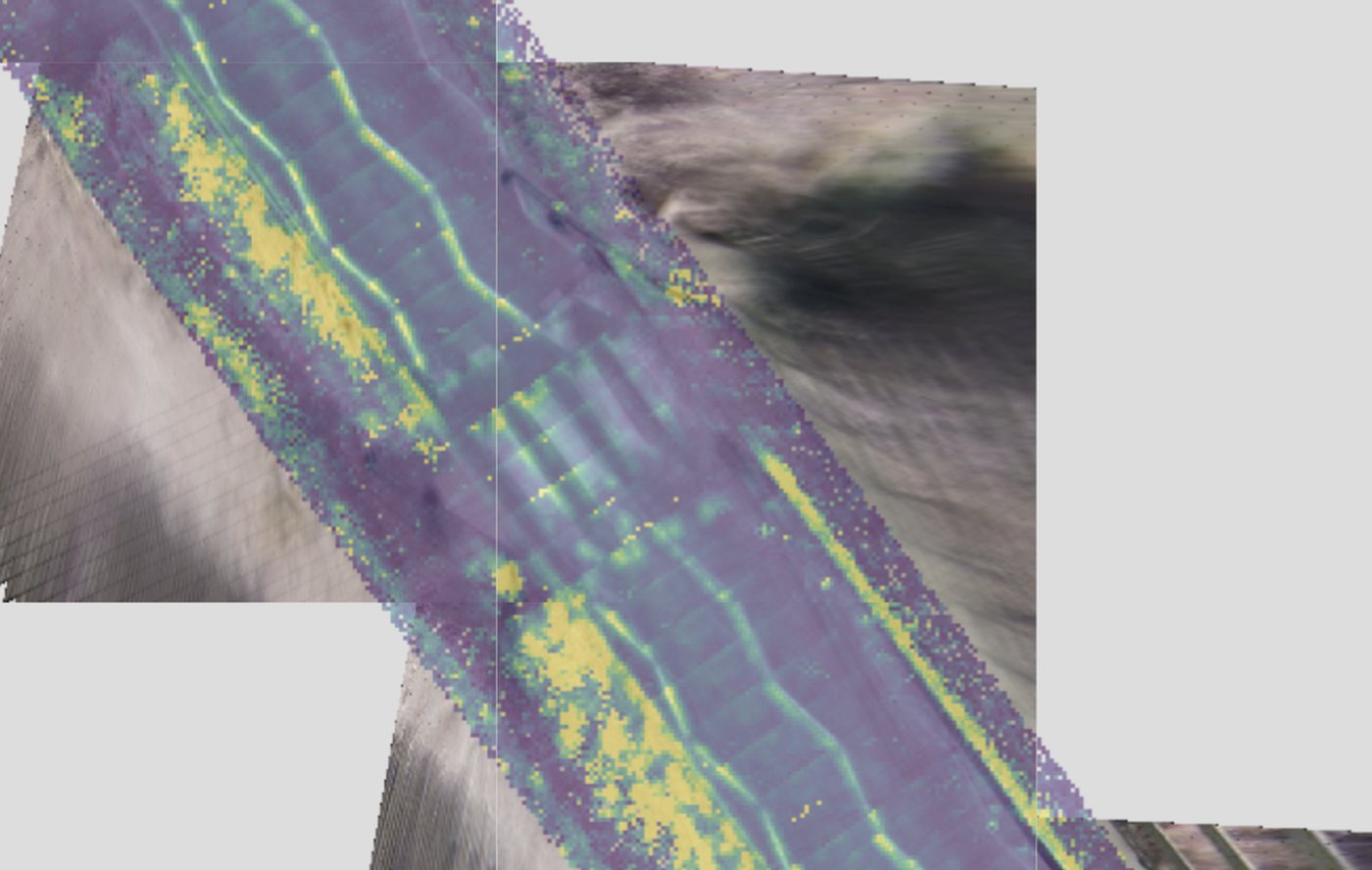 Classified aerial LiDAR point cloud over a road corridor, coloured by return intensity, with surrounding terrain tiles.
